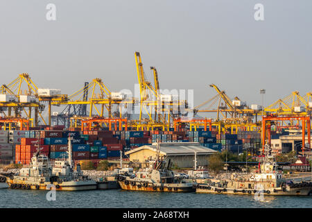 Laem Chabang Seehafen, Thailand - 17. März 2019: chaotische Szene der Container Terminal mit gelben Krane, Stapel von farbigen Kästchen und ein paar Schlepper in Stockfoto