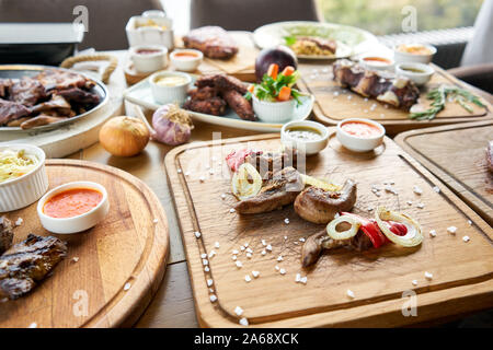 Lamm Zunge Kebab mit Sauerkraut und zwei Saucen. Grill Restaurant Menü. Viele verschiedene Lebensmittel auf dem Tisch. Dinner Party oder Bankett Stockfoto