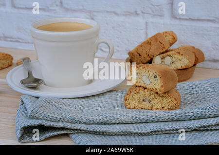 Hausgemachte Kekse Cantuccini, Italienisch Mandeln Süßigkeiten Kekse mit Tasse Kaffee auf woodem Tabelle. Frische Italienische cookies cantucci Hintergrund. Stockfoto