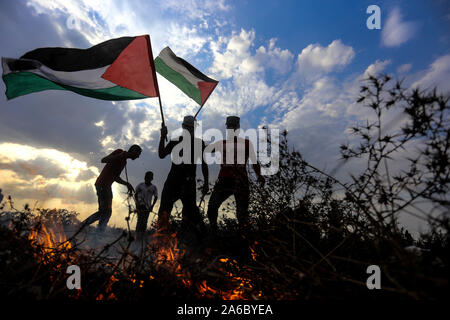 Gaza, Palästina. 25 Okt, 2019. Die Demonstranten halten Palästinensischen Fahnen bei Auseinandersetzungen mit israelischen Truppen in der Nähe des südlichen Gazastreifen Stadt von Khan Younis, Okt. 25, 2019. Credit: Yasser Qudih/Xinhua/Alamy leben Nachrichten Stockfoto