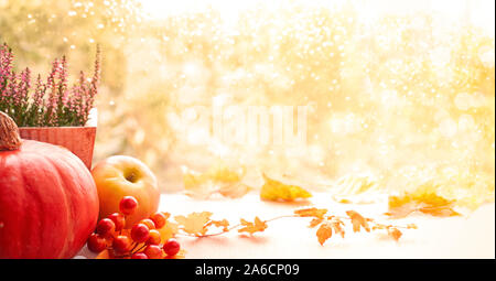 Herbst Hintergrund mit Kürbis, Äpfel, Heidekraut und trockene Blätter auf einem Fenster Board an einem regnerischen Tag, Panoramic Image Stockfoto