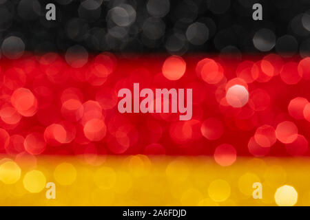 Abstract Roter Hintergrund mit bokeh Leuchten, Schwarz Rot Gelb patriotischen Fahne mit Defokussierten Glitzereffekt, festlich bunten Vorlage Stockfoto