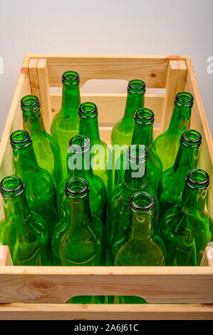 Leere Weinflaschen in einer Holzkiste auf dem Tisch. Home Weinbereitung Stockfoto