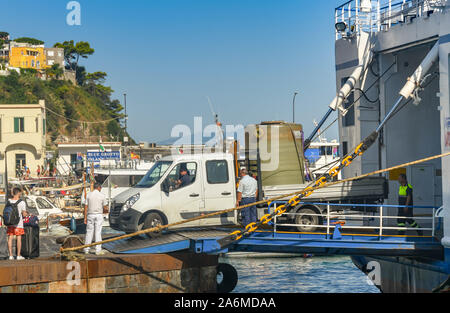 Insel Capri, Italien - AUGUST 2019: Lkw mit einem großen Behälter an der Rückseite fahren über eine Fähre im Hafen auf der Insel Capri. Stockfoto