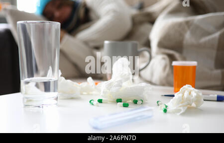 Frau wird krank und liegt auf einem Sofa zu Hause leiden Stockfoto