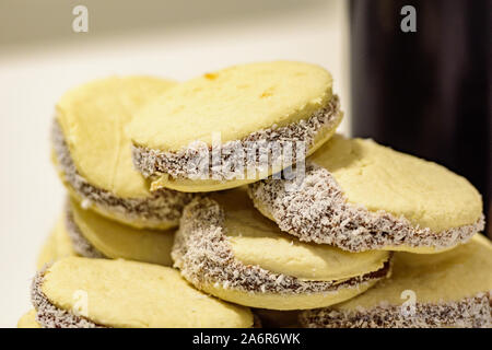 Mate und leckere argentinische und uruguayische Cookies alfajores mit Sahne auf Papier Nahaufnahme auf dem Tisch. Horizontal. Mate Drink traditionell in Urugua Stockfoto