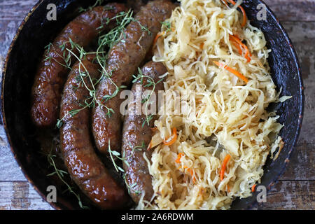 Bayerische Würste in einer Pfanne mit Schmorkohl. Oktoberfest essen. Selektive konzentrieren. Makro. Stockfoto