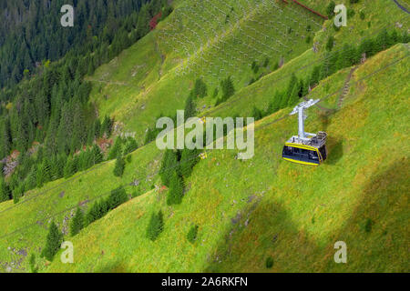 Gelbe Seilbahn von Bergdorf Wengen zu Viewpoint auf Klippe in Mannlichen, Schweiz, Berner Oberland Stockfoto