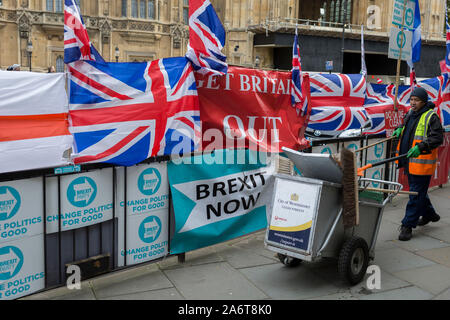 An dem Tag, an dem die EU in Brüssel im Grundsatz vereinbart Brexit zu verlängern bis zum 31. Januar 2020 (alias "Flextension") und nicht bis zum 31. Oktober 2019, ein Westminster borough Street cleaner Wurf neben Brexit Partei Fahnen und Banner während eines Brexit Protest außerhalb des Parlaments aufhebt, am 28. Oktober 2019, in Westminster, London, England. Stockfoto