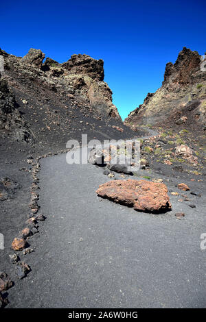 In einem Pfad, der Vulkan El Cuervo auf Lanzarote, einer der wenigen Vulkane, wo es erlaubt ist zu gehen. Stockfoto