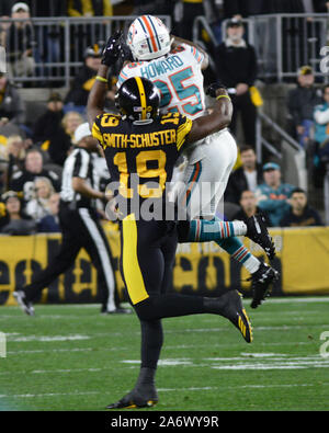 Miami Dolphins cornerback Xavien Howard (25) laughs as he celebrates  scoring a touchdown with Miami Dolphins cornerback Kader Kohou (28), Miami  Dolphins defensive tackle Raekwon Davis (98) and Miami Dolphins linebacker  Melvin Ingram (6