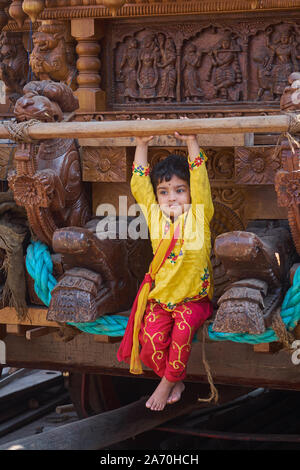 Während eines Festivals um Balkrishna Tempel in Udipi, Karnataka, Indien, ein festlich gekleideten Mädchen sitzt auf einem Wagen für Idol des Tempels verwendet Stockfoto
