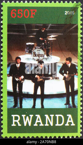 Die Beatles spielen auf Briefmarke von Ruanda Stockfoto