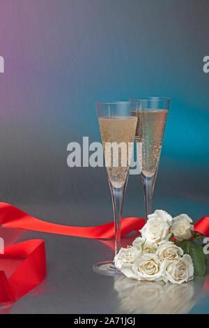 Noch immer leben von zwei champagnergläser auf einem Tisch mit roter Schleife und weißen Rosen Stockfoto