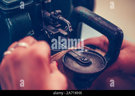 Frau Schuster Hände nähen ein Teil des Schuhs an einem Workshop Stockfoto