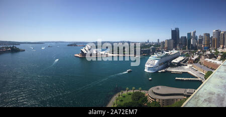 Die beeindruckende Skyline von Sydney mit dem Opernhaus von Sydney und ein Karneval Kreuzfahrtschiff von Sydney Harbour Bridge. Stockfoto