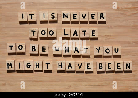 Es ist nie zu spät, das zu sein, was Sie gewesen sein könnte. Motivierende Worte in 3d Holz- Alphabet Buchstaben auf einem Bambus Holz Hintergrund Stockfoto