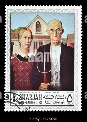 Storniert Briefmarke gedruckt von Sharjah, das zeigt Gemälde von Grant Wood, circa 1968. Stockfoto