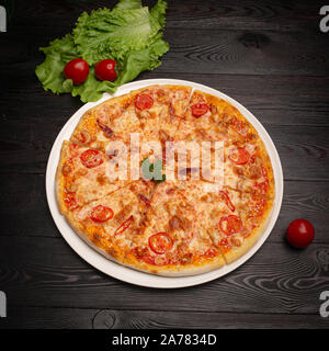 Sortierte Pizza in Stücke auf einem dunklen Hintergrund, in Scheiben geschnitten Stockfoto