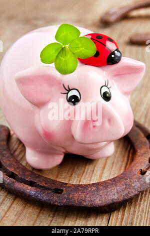 Lucky Symbole - viel Glück Sparschwein Horseshoe und Four Leaf Clover Stockfoto