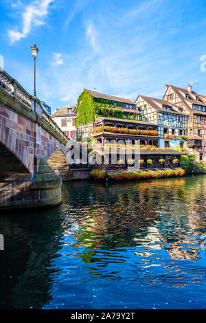 Die Saint-Martin Brücke und Fachwerkhäuser mit pastellfarbenen Fassaden entlang der Ill in der Petite France Viertels in Straßburg, Frankreich. Stockfoto