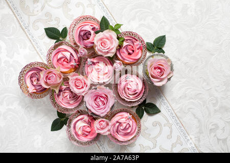 Eine schöne Zusammenstellung von Pink und rosa Schale Kuchen auf einem luxuriösen Tabelle einstellen Stockfoto