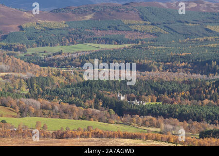 Eine Anzeige der herbstlichen Laub im Cairngorms Nationalpark mit Balmoral Castle und Crathie Kirche sichtbar oberhalb der Bäume Stockfoto