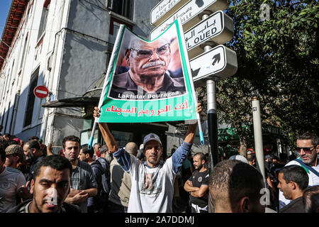 Algier, Algerien. 01 Nov, 2019. Eine algerische Demonstrant hält einen Banner mit dem Foto von lakhdar Bouregaa, einem bekannten Krieg Veteran, der von den Behörden im letzten Sommer verhaftet, während einer Demonstration gegen die Regierung den Sturz von Beamten, die unter ex serviert zu verlangen - Präsident Abdelaziz Bouteflika, wie sie der 65. Jahrestag des Landes der Kampf für Unabhängigkeit von Frankreich geprägt. Credit: Farouk Batiche/dpa/Alamy leben Nachrichten Stockfoto