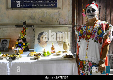 Merida Frau vor ihrer Familie Altar während Hanal Pixan ist die Feier des Tages der Toten, die von der Maya-kultur stammt. Merida, Yucatan, Mexiko Stockfoto