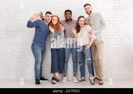 Hi, gibt! Freunde winkende Hände zu Kamera Stockfoto