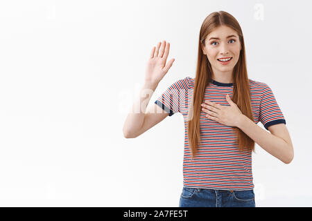 Mädchen, versprechen Sie. Fröhliche aufrichtigen guten, freundlichen jungen cute woman in gestreiften T-Shirt, halten sie die Hand erhoben und auf Herz, suchen Kamera Stockfoto