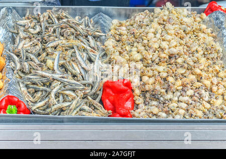 Gebratenen kleinen Tintenfischen und Sardellen, in einer Strasse portable Restaurant gekocht. Berühmte Essen im Süden von Spanien, Andalusien. Stockfoto