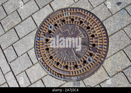 Kanaldeckel auf der Straße in Berlin. Stockfoto