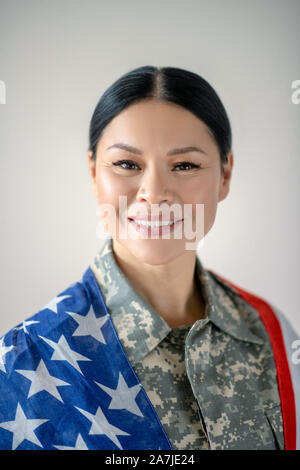 Aufgeregt Asiatischen militärische Frau lächelnd während sie aufgeregt Gefühl Stockfoto