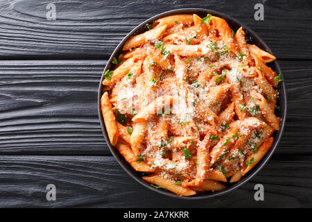 Penne Alla Vodka ist ein klassisches italienisches Pastagericht mit Penne in einer cremigen Soße aus Tomaten und Wodka zu schließen, in einen Teller auf dem Tisch. Horizontal oben v Stockfoto