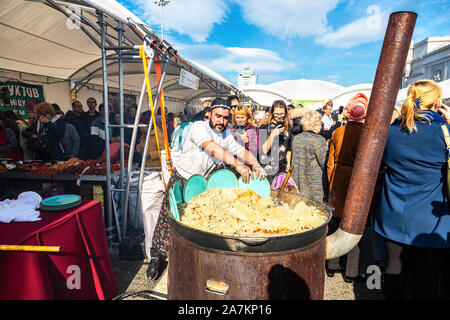 Samara, Russland - Oktober 5, 2019: Kochen appetitlich traditionelles orientalisches Pilaw in einem großen Kessel im Freien während des Urlaub Stockfoto