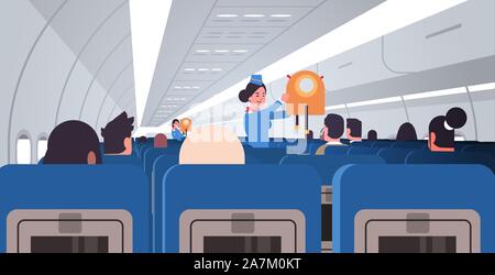 Stewardess Flugbegleiterin erklären, für Passagiere wie Jacke Schwimmweste im Notfall Sicherheit demonstration Konzept moderne Flugzeug der inneren horizontalen flachen Vector Illustration zu verwenden Stock Vektor