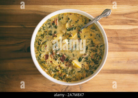 Blick von oben auf eine Schüssel mit würzigen Zuppa Toscana mit Wurst, Speck, Grünkohl und Kartoffeln. Stockfoto