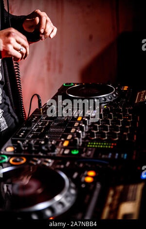 DJ spielt live und Mischen von Musik auf Drehsockel Konsole im Stadium der Night Club. Disk Jokey Hände auf einem Mischpult Station im Club Party. DJ-Mixer Stockfoto