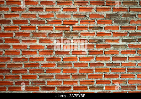 Rot und Orange Wand Textur Hintergrund. Ziegelwerk home Architektur Innenraum. Loft Design von zu Hause. Brick Wall vintage Hintergrund. Mauerwerk Stockfoto