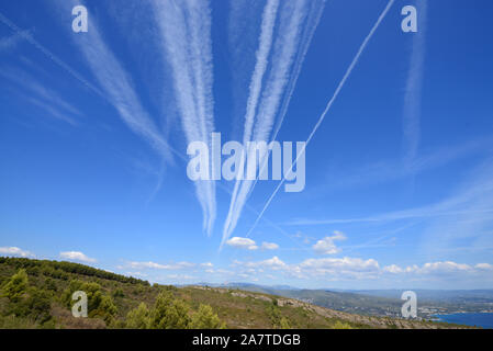 Kondensstreifen, Kondensstreifen, Kondensstreifen, Line-Shaped Wolken oder Homogenitus konvergierenden zu Fluchtpunkt im blauen Himmel Stockfoto