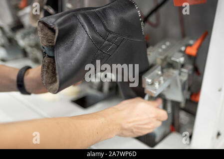 Bildet den vorderen Teil auf einer speziellen Maschine. Schuhproduktion. Stockfoto