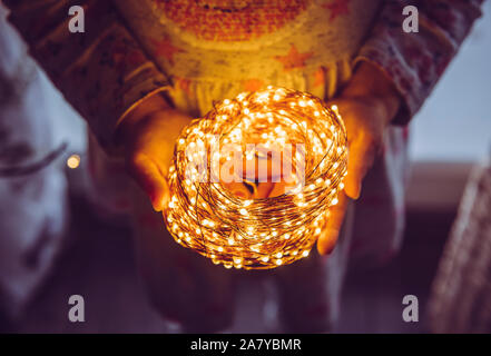 Nahaufnahme Blick von oben auf die Person, die Rolle von Kabel Micro LED-string Lichter in den Händen. Stockfoto