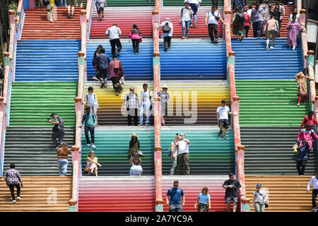 Kuala Lumpur, Malaysia, November 05, 2019. Touristen klettern eine bunte Treppe, die zu den Batu Höhlen. Batu Höhlen ist ein Hügel aus Kalkstein mit einer Reihe Stockfoto