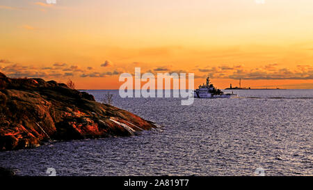 Die herbstlichen Marine bei Sonnenuntergang mit Küstenwache Boot Richtung Horizont reisen. Kustaanmiekka, Suomenlinna, Finnland. Oktober 2019. Digital verbessern Stockfoto