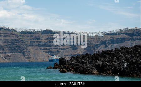 Nea Kameni Island, Griechenland - 16 Juli 2019: ein Kreuzfahrtschiff vor Anker gegangen Fira von der Vulkaninsel Nea Kameeni gesehen Stockfoto