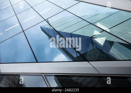 Reflexionen in hohen Bürogebäuden Windows aus anderen Wolkenkratzer in der City von London, Großbritannien im November. Stockfoto