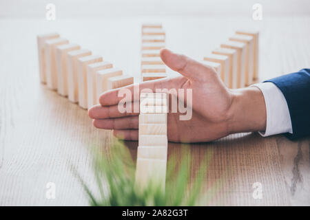 Der Risk Manager zum Schutz Holzkeile von Domino Effekt 7/8 Stockfoto