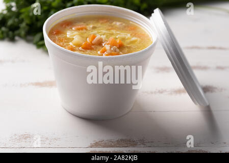Gemüsesuppe in einem Einwegflaschen aus Plastik Schüssel mit Deckel, auf weißem Hintergrund. Schnell & einfach essen Konzept. Essverhalten, Lebensmittel-lieferservice. Stockfoto