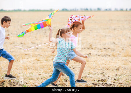 Kleine Kinder Drachen steigen im Freien Stockfoto